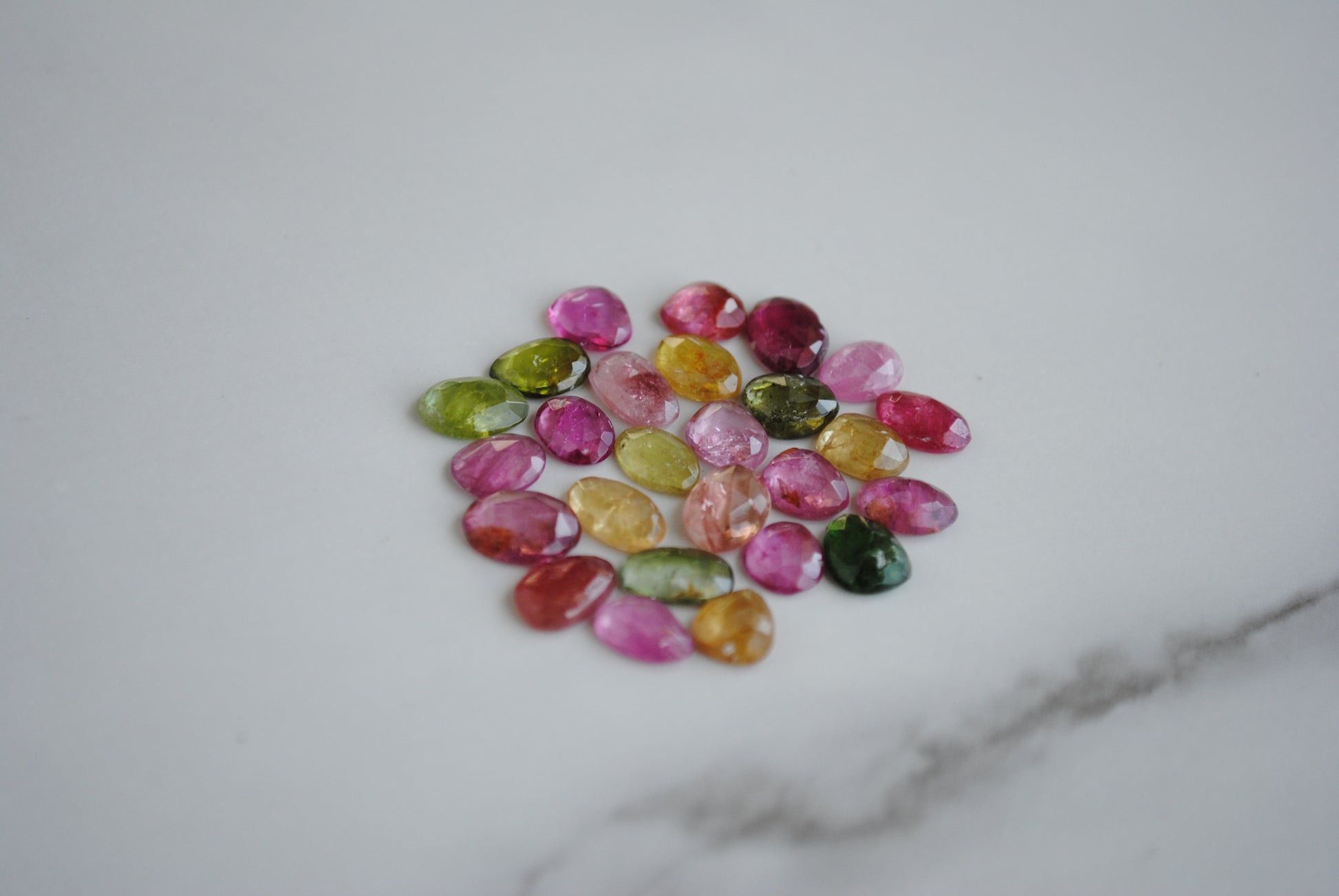 Tourmaline rose cut cabochons on light background
