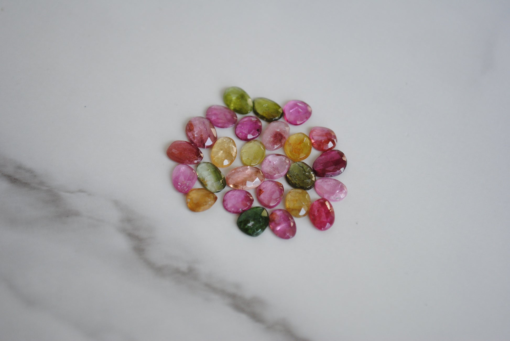 Tourmaline rose cut cabochons on light background