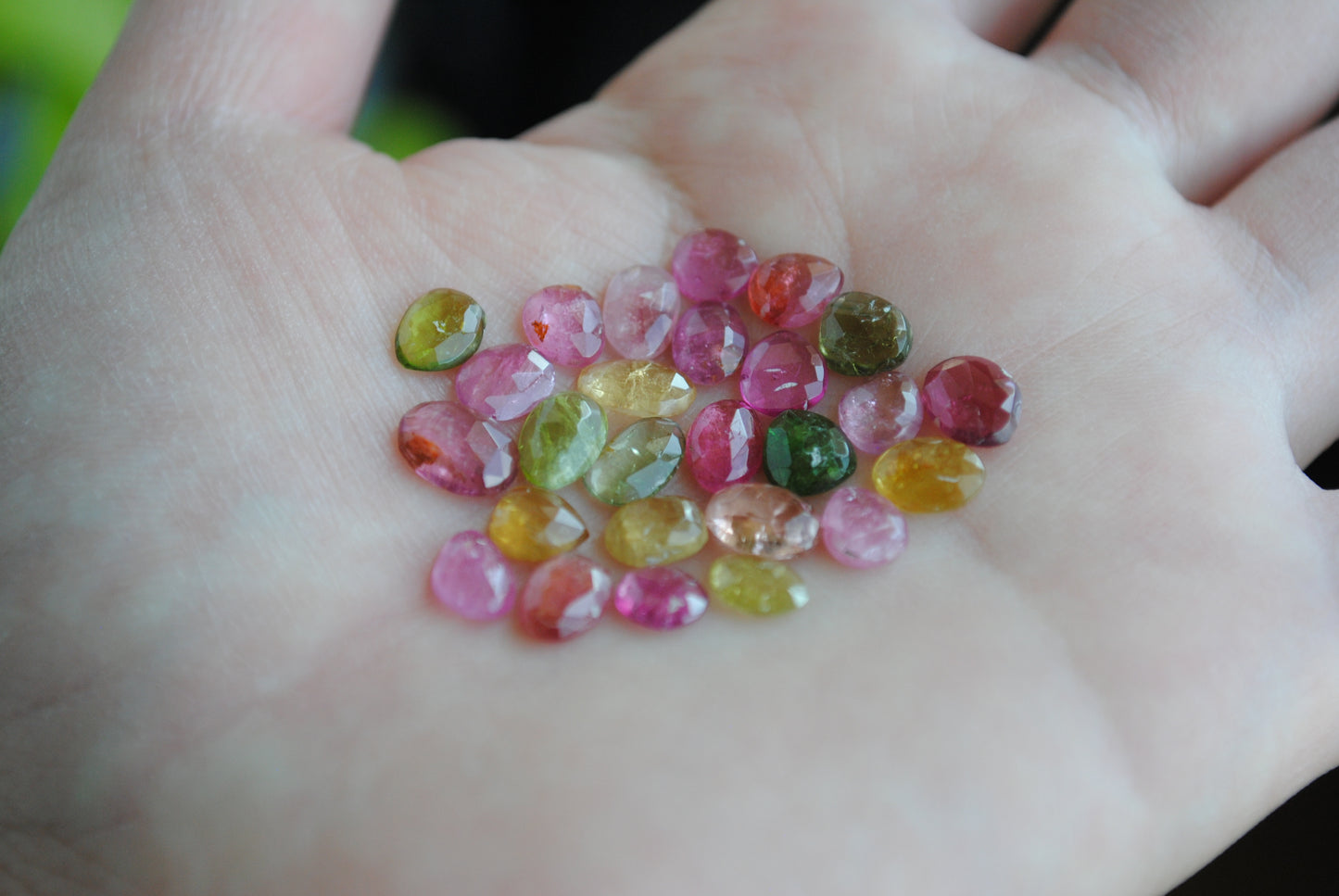 Tourmaline rose cut cabochons on palm of hand