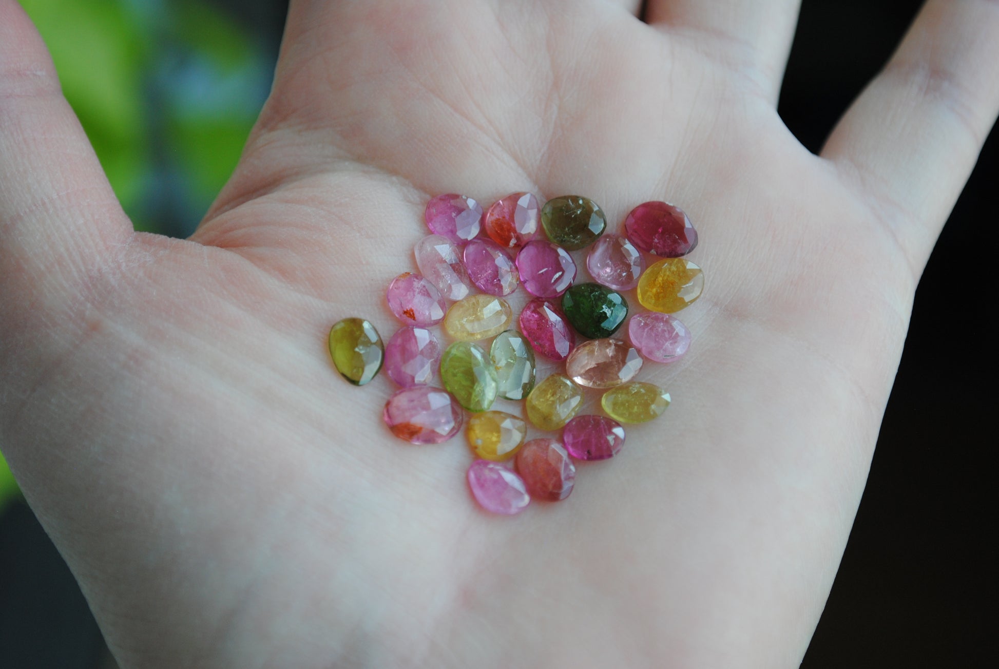 Tourmaline rose cut cabochons on palm of hand