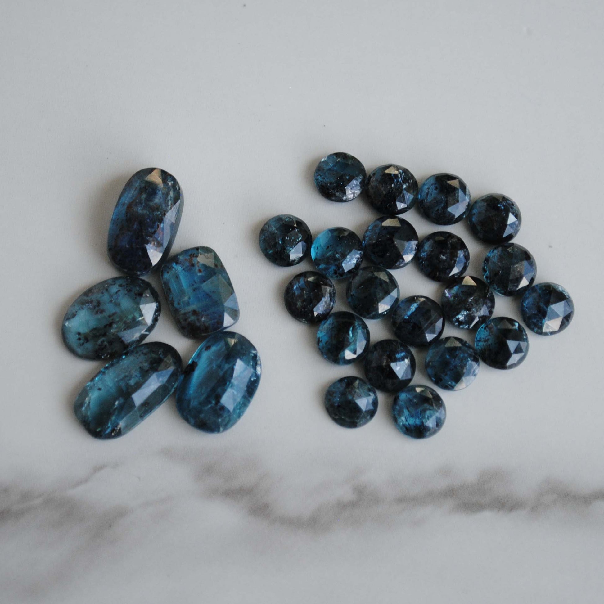 Kyanite rose cut cabochons on light background
