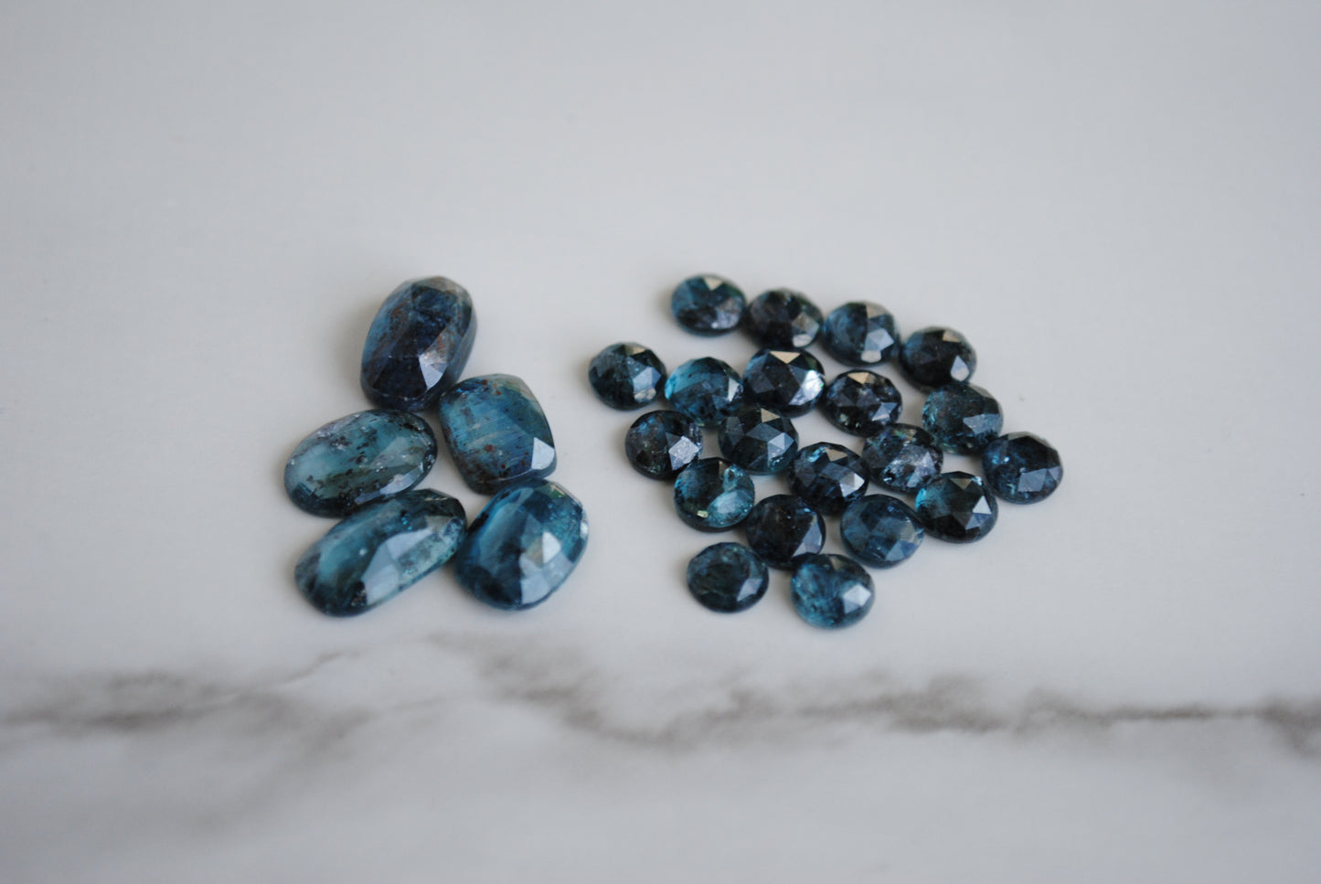 Kyanite rose cut cabochons on light background