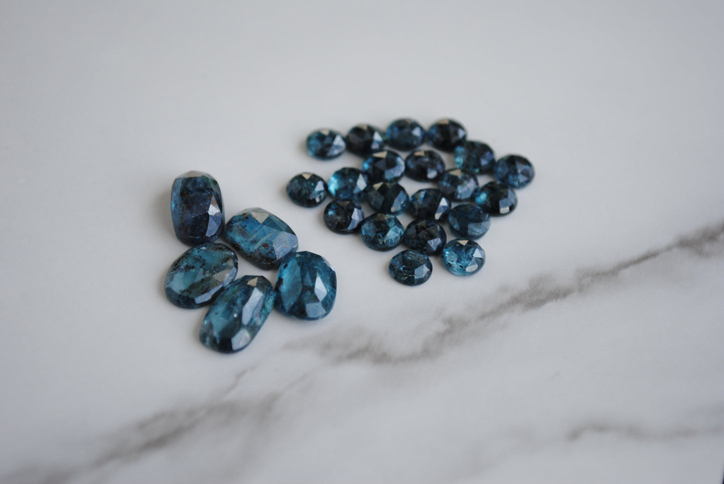 Kyanite rose cut cabochons on light background
