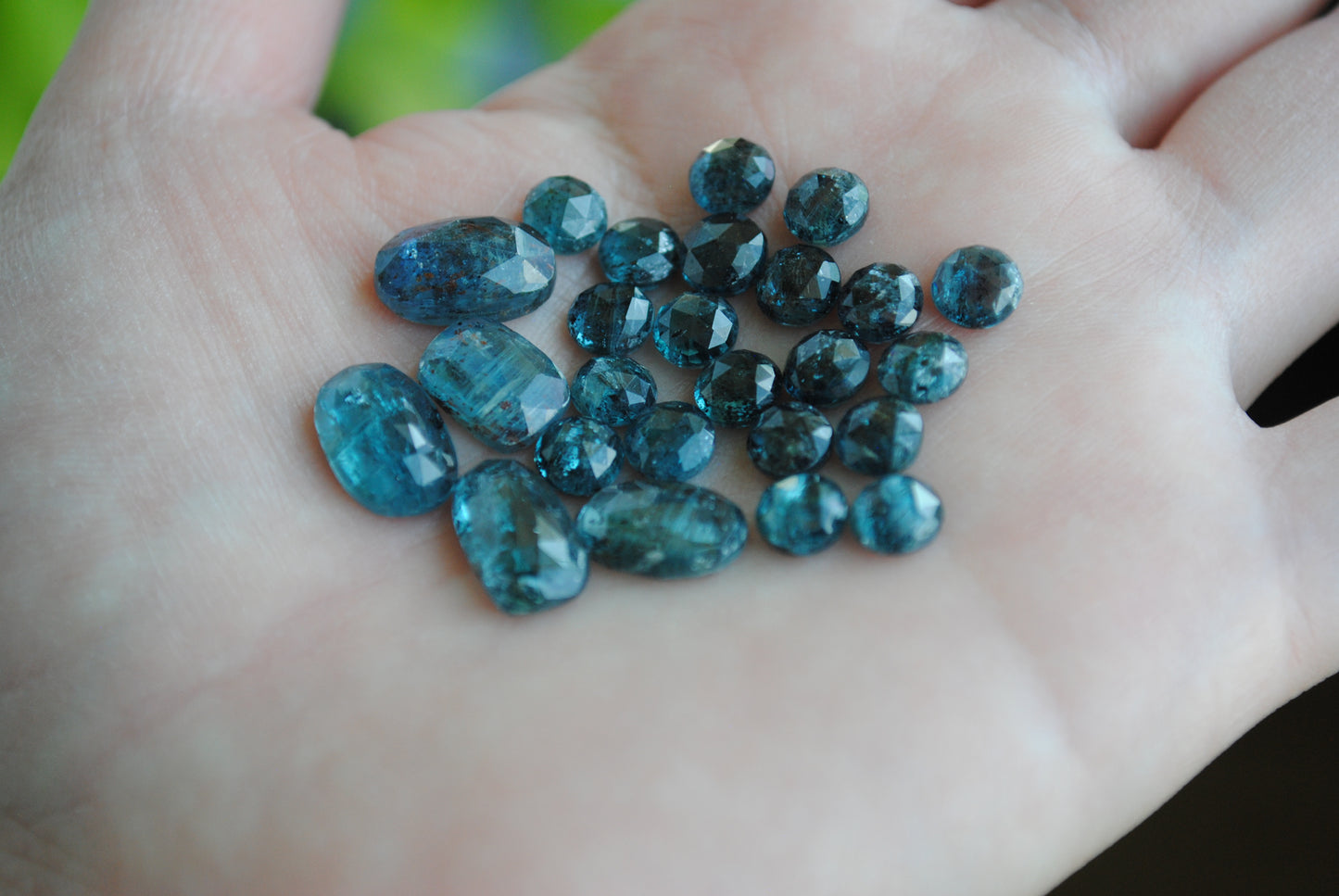 Kyanite rose cut cabochons on palm of hand
