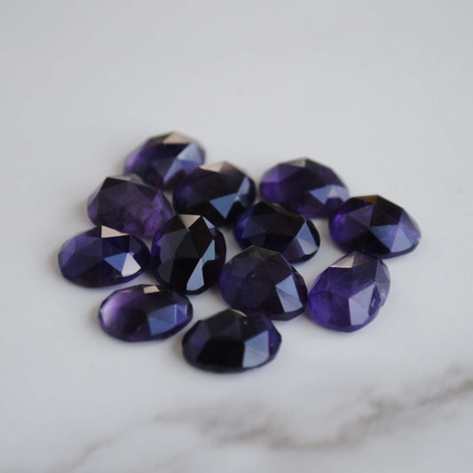 Amethyst rose cut cabochons on light background