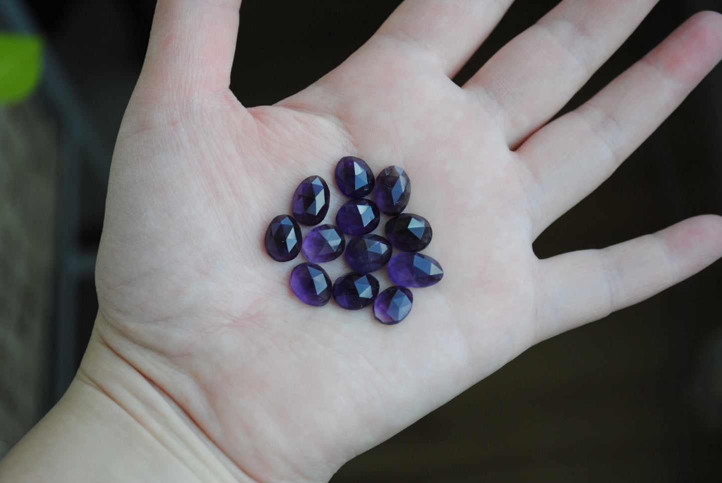 Amethyst rose cut cabochons on palm of hand
