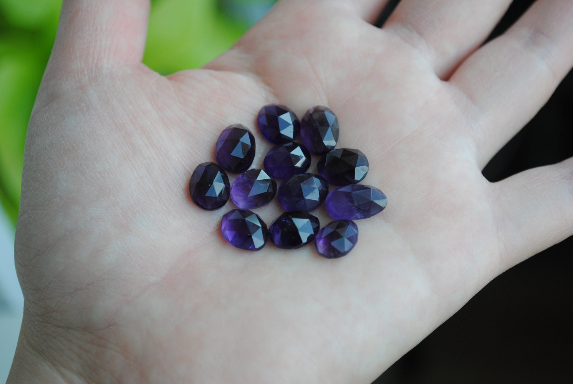 Amethyst rose cut cabochons on palm of hand