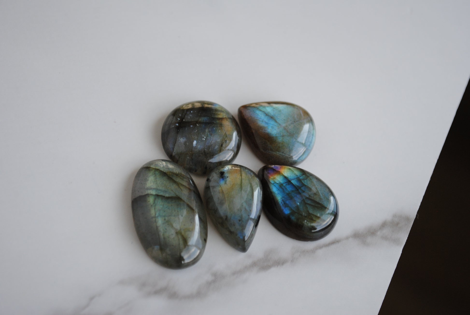 Labradorite cabochons on light background