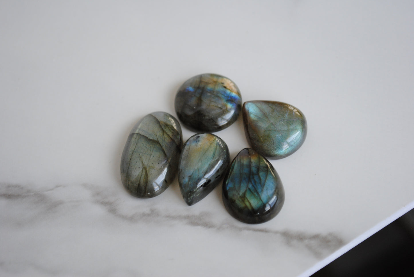 Labradorite cabochons on light background