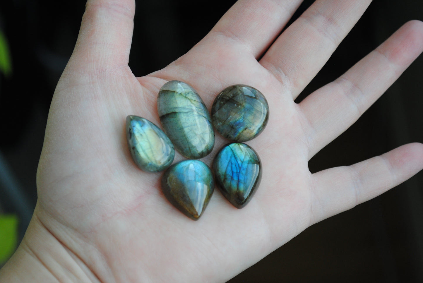 Labradorite cabochons on palm of hand