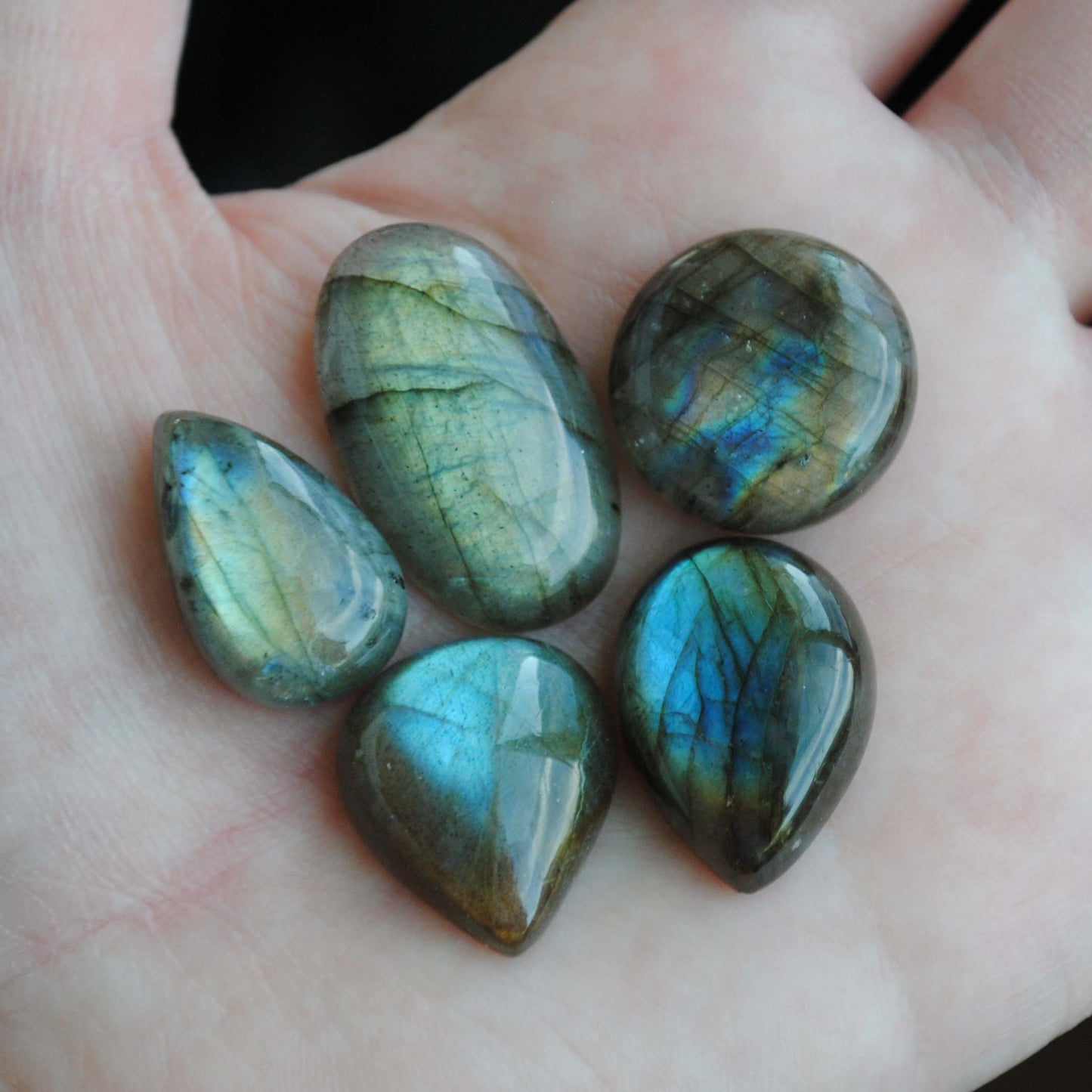 Labradorite cabochons on palm of hand