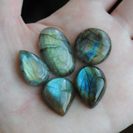Labradorite cabochons on palm of hand