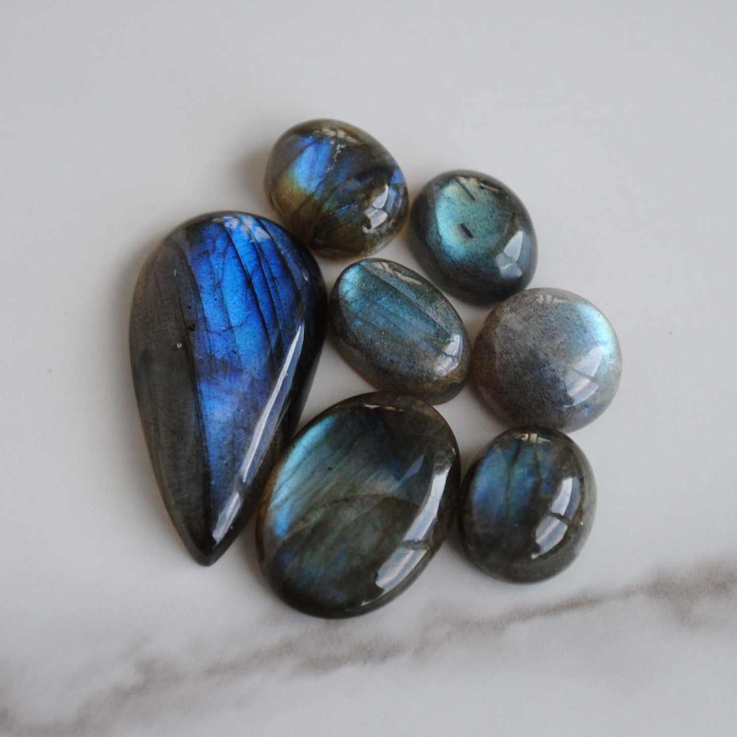 Labradorite cabochons on light background
