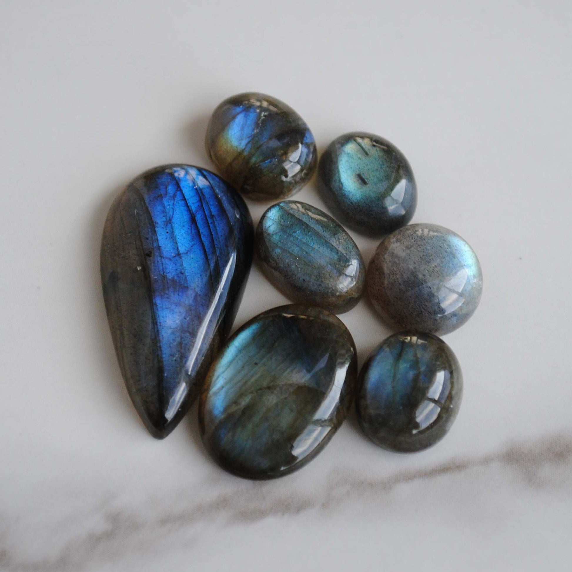 Labradorite cabochons on light background
