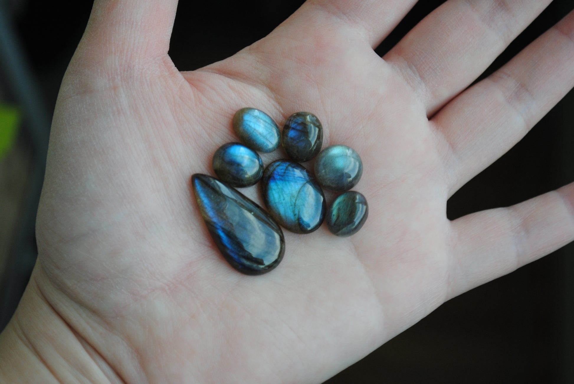 Labradorite cabochons on palm of hand