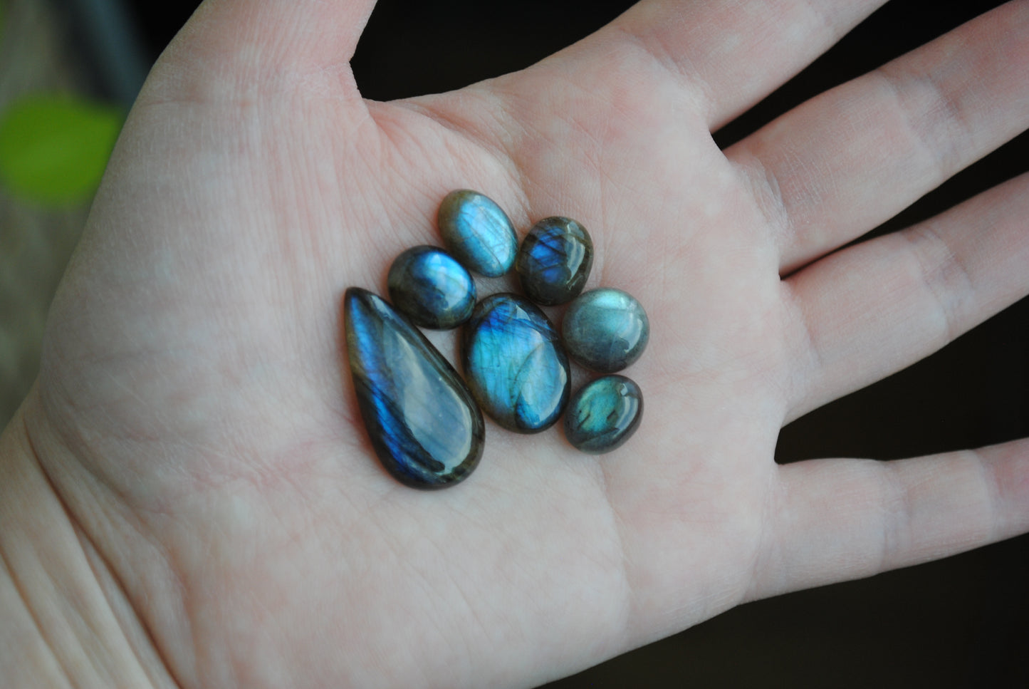 Labradorite cabochons on palm of hand