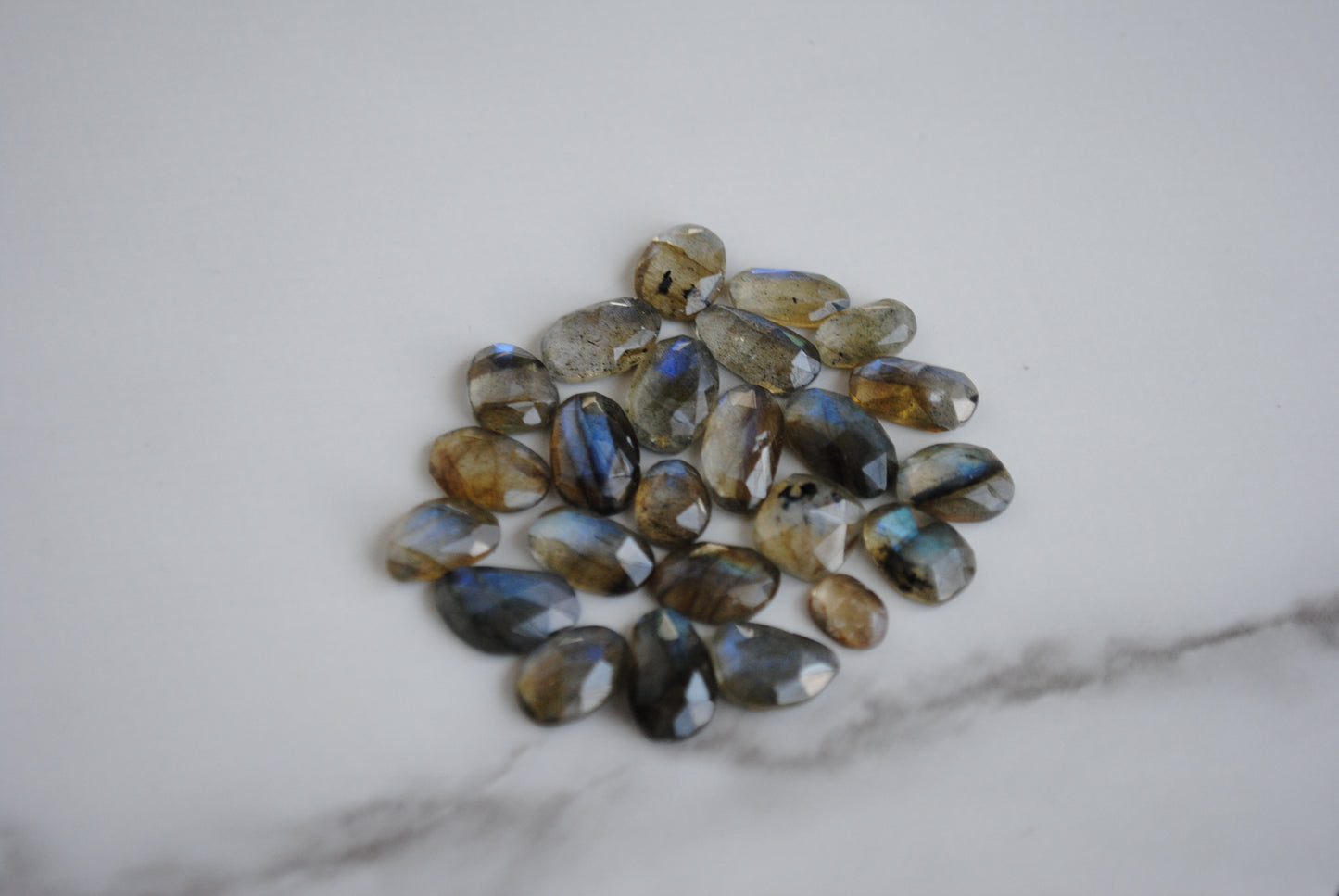 Labradorite rose cut cabochons on light background