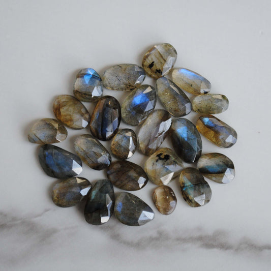 Labradorite rose cut cabochons on light background